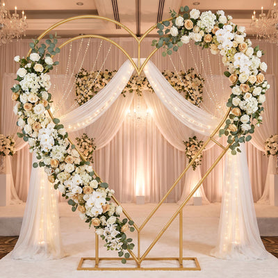 Elegant gold heart wedding arch with white floral and draped chiffon decor