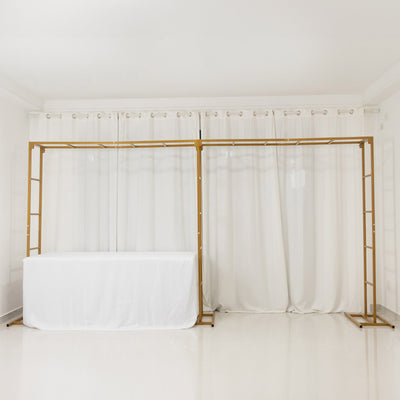 Gold display frame with white tablecloth against a plain backdrop