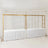 Gold frame display stands with white table covers in a staged setting.