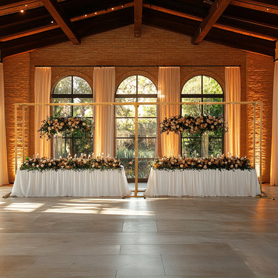 Elegant event setup with floral arrangements and candles in a beautifully lit venue.