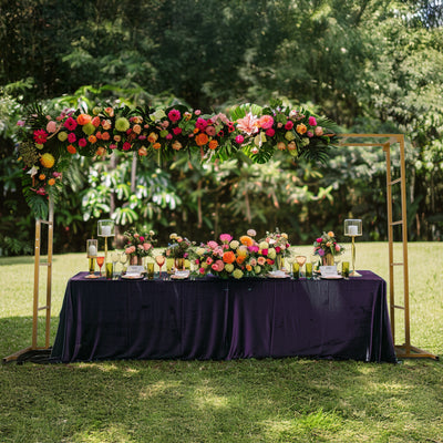 Elegant floral wedding backdrop with vibrant flowers and table decor.