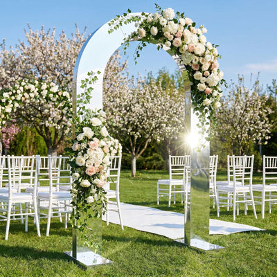 Elegant floral wedding arch with white chairs in an outdoor garden ceremony