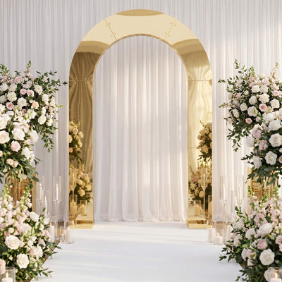 Elegant wedding arch with gold accents, white drapes, and floral aisle decor