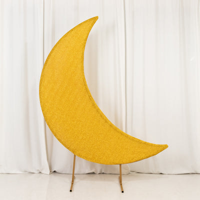 Yellow glitter crescent moon decoration on a stand against a white backdrop.