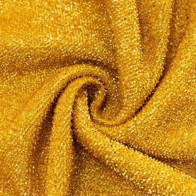 Shimmering gold fabric with a textured surface, ideal for fashion and design.