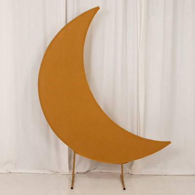 Orange crescent moon-shaped decor piece on a plain backdrop
