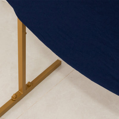 Navy tablecloth draped over a gold metal table leg