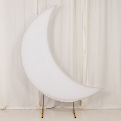 Moon-shaped lamp on wooden stand against white backdrop
