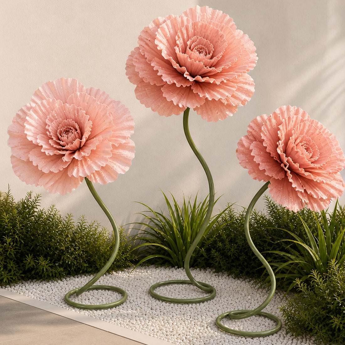 Pink sculptural flowers in a modern garden with green stems and white pebbles