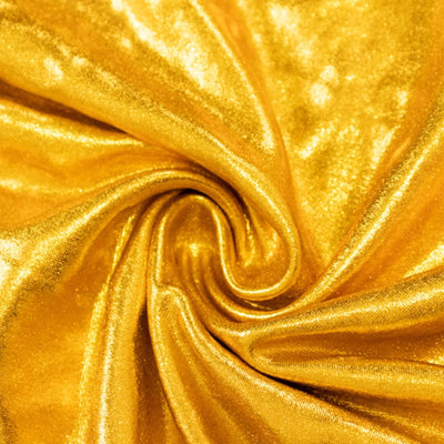 Shimmering gold satin fabric swirl texture close-up#whtbkgd