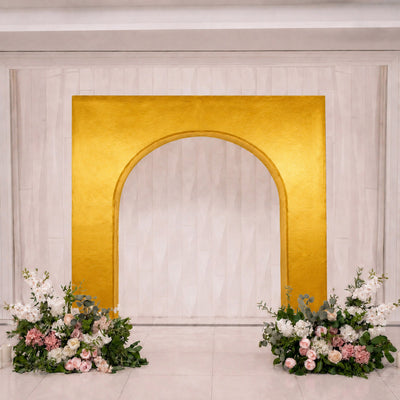 Elegant gold arch wedding backdrop with floral arrangements