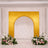 Elegant gold arch wedding backdrop with floral arrangements