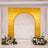 Gold arch wedding backdrop with white curtains and floral arrangements