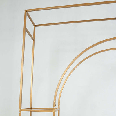Gold metal arch display stand on a plain backdrop.