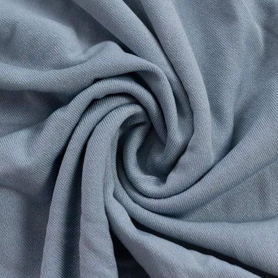 Close-up of folded light gray fabric texture with spiral drape#whtbkgd