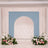 Pastel wedding arch backdrop with floral arrangements on both sides