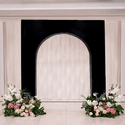 Elegant wedding arch with floral arrangements and black backdrop backdrop