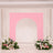 Pink arch wedding backdrop with white flowers and floral arrangements
