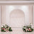 Elegant wedding backdrop with white arch and pink floral arrangements