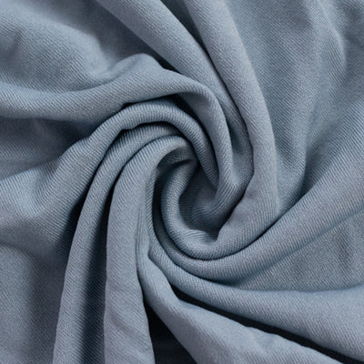 Soft blue fabric texture close-up, showcasing its smooth drape and quality.