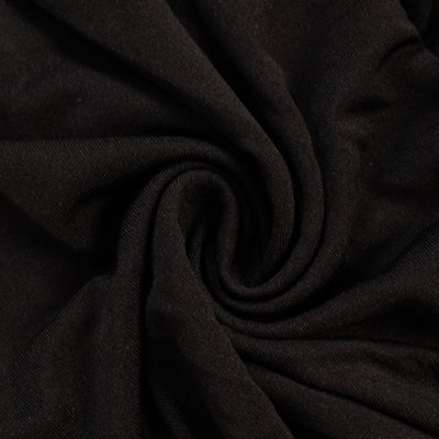 Black fabric with a smooth, soft texture in a swirling pattern.