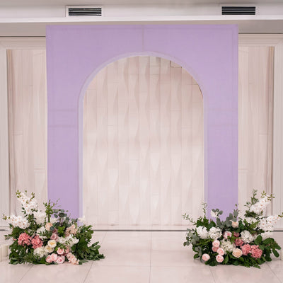 Elegant purple arch with floral arrangements for events or weddings.