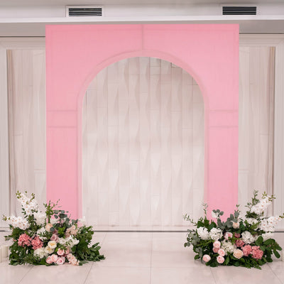 Pink arch backdrop with floral arrangements for events or weddings.
