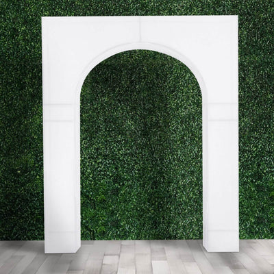 White archway against a green foliage backdrop.