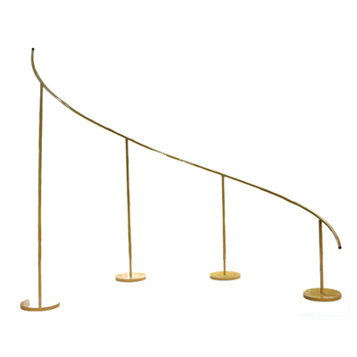 Curved gold railing with four stands on a white background