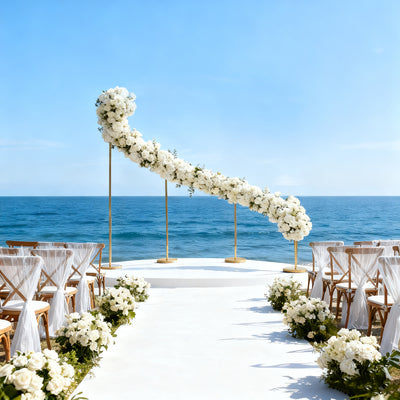 Beautiful floral wedding arch overlooking the ocean with elegant seating.