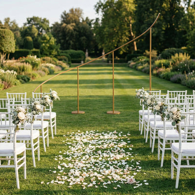 Elegant outdoor wedding setup with chairs, floral arrangements, and a decorative arch.