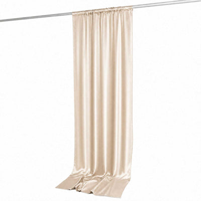 Champagne satin curtain panel hanging on a rod, elegant draped window treatment