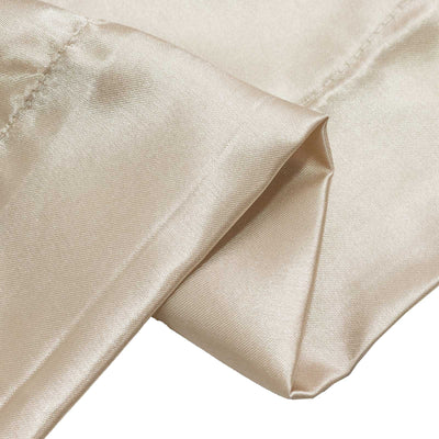 Champagne satin fabric close-up with soft folds and sheen