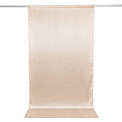 Beige satin backdrop curtain hanging on a rod, seamless studio background