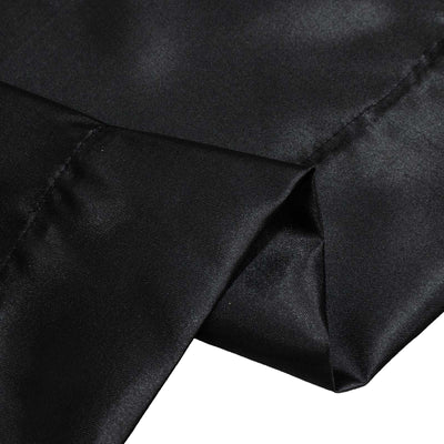 Black woven fabric close-up with folds and textured stitching
