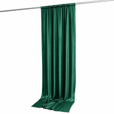 Green satin curtain panel hanging on a rod against a white background