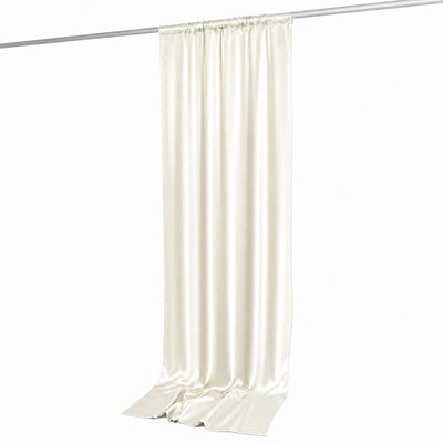 Cream silk curtain panel hanging on a rod against a white background