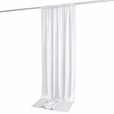 White satin draped curtain panel hanging on rod
