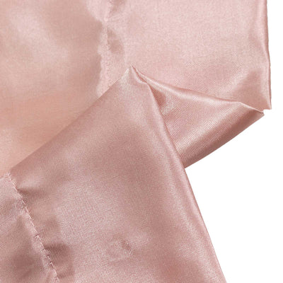 Rose pink satin fabric close-up with soft folds and sheen