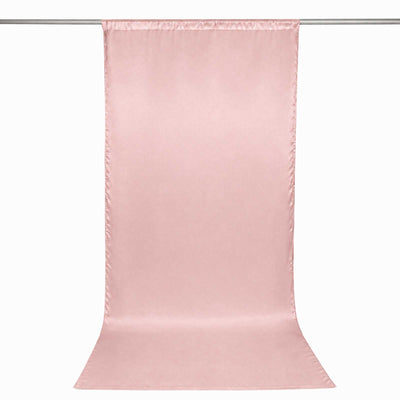 Pink satin backdrop curtain hanging from a rod, minimalist studio background