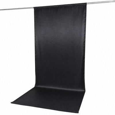 Black photo backdrop curtain with floor sweep on hanging rod