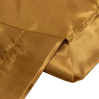 Gold satin fabric close-up with elegant folds and sheen
