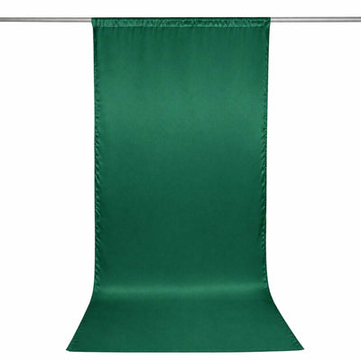 Green satin photography backdrop curtain on a rod, isolated on white background