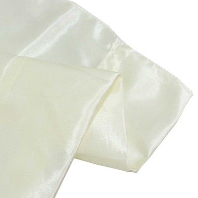Cream satin fabric close-up with soft folds and sheen