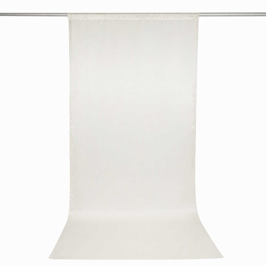 Off-white sheer curtain panel with rod pocket hanging on curtain rod