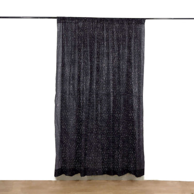 Black sheer curtain with silver star pattern, elegantly draped.