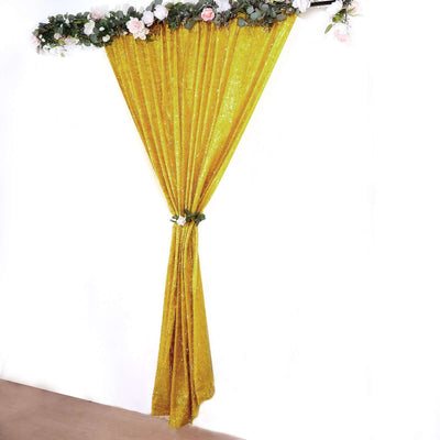 Gold sequin curtain draped elegantly with floral accents