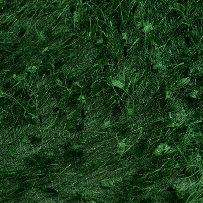 Green textured fabric with delicate leaf patterns.