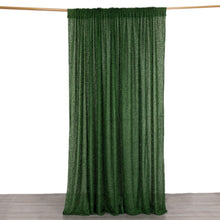 A polyester green shaggy fringe curtain is hanging on a wooden pole