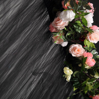 Floral arrangement with pink and white roses against a textured black background.